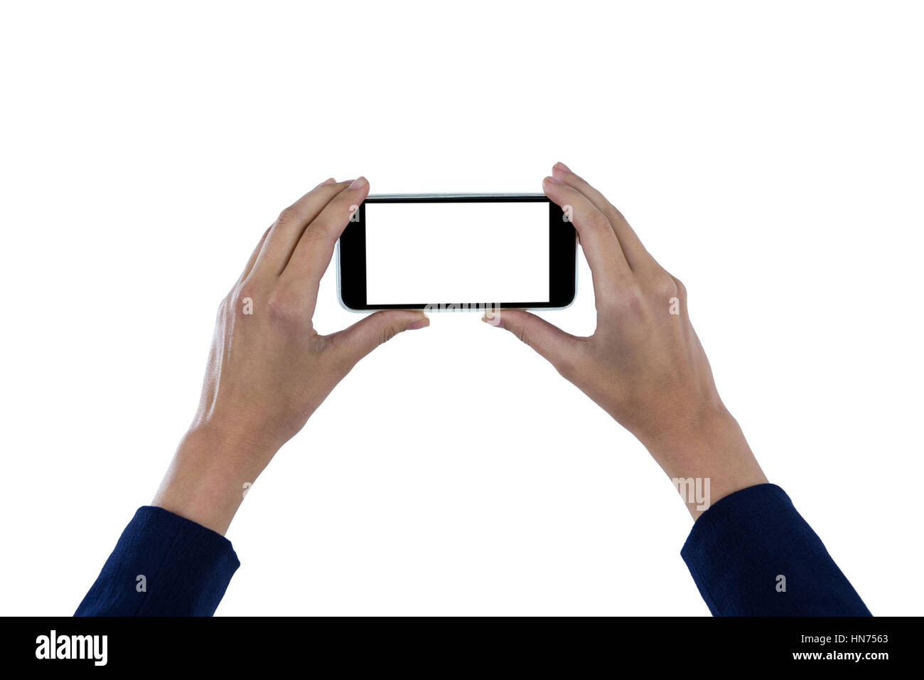 Hand of businesswoman holding mobile phone against white background Stock Photo