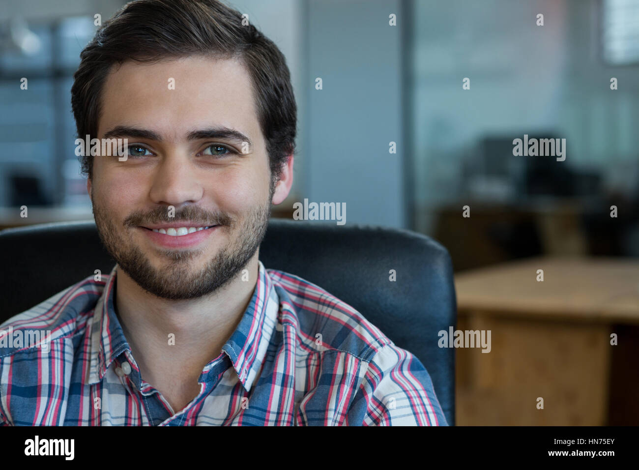 Portrait of smiling businessman in office Stock Photo - Alamy