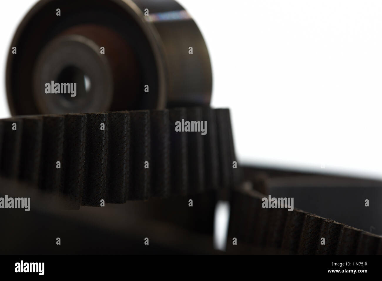 teeth of timing belt with roller isolated on white Stock Photo Alamy
