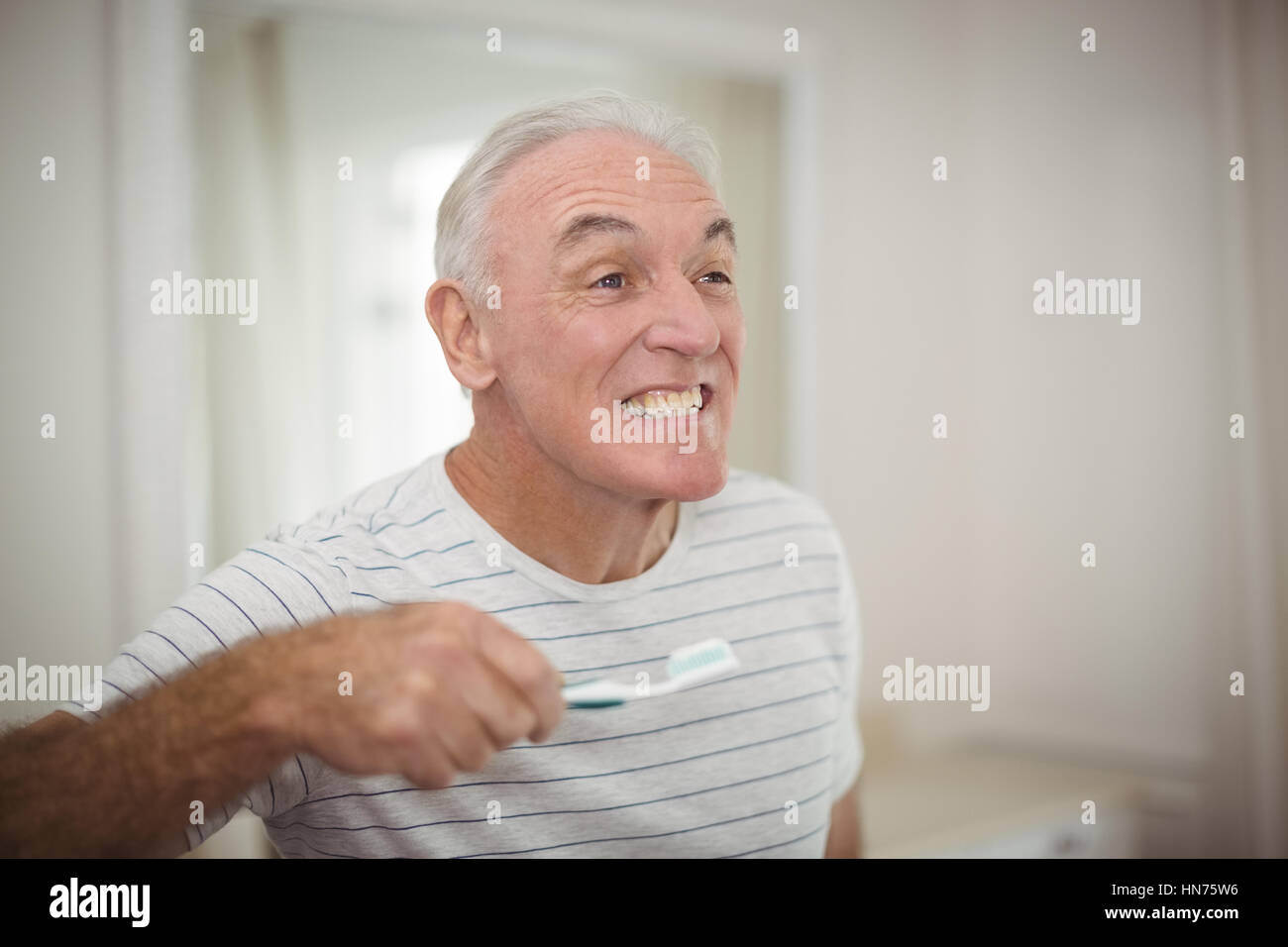 Taking Toothbrush Man Portrait of senior man holding toothbrush in bathroom at home Stock ...