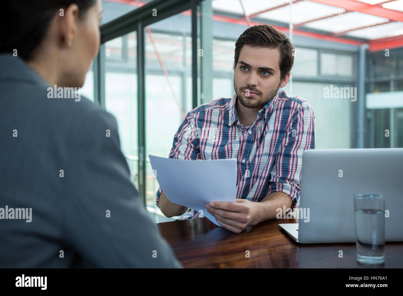Business Executive Conducting Job Interview With Woman In Office Stock
