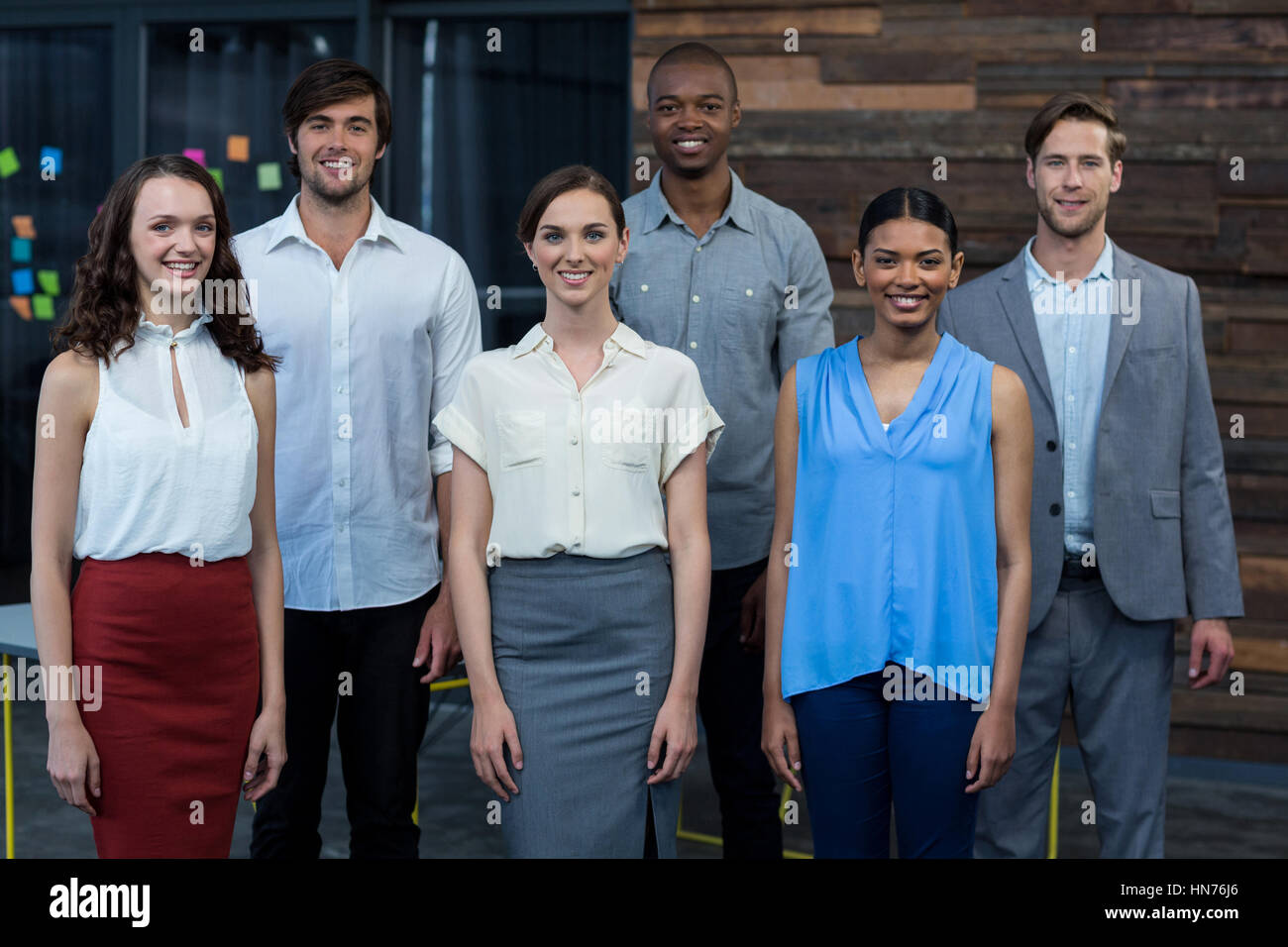 Portrait of business executives standing together in office Stock Photo ...