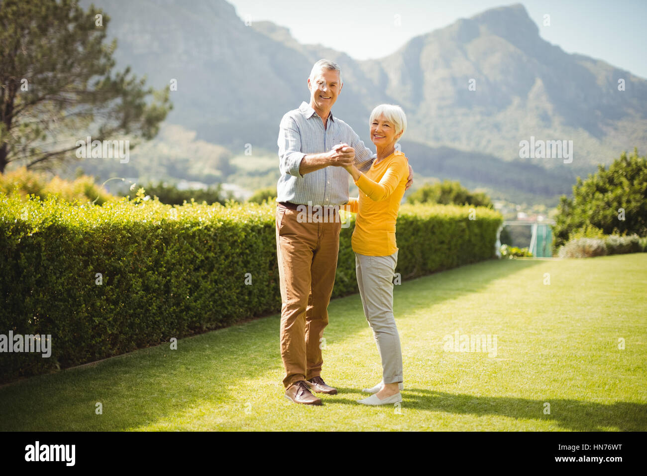 Portrait of happy senior couple dancing in park Stock Photo - Alamy