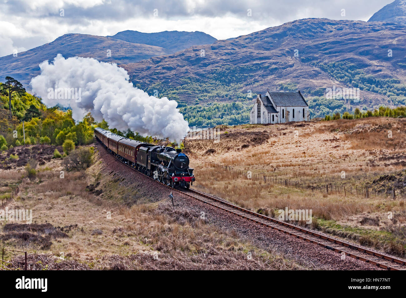 Stanier Class 5 4-6-0 No. 45231 steam engine powers The Jacobite past the church at Polnish West Highlands of Scotland UK en route to Mallaig Stock Photo