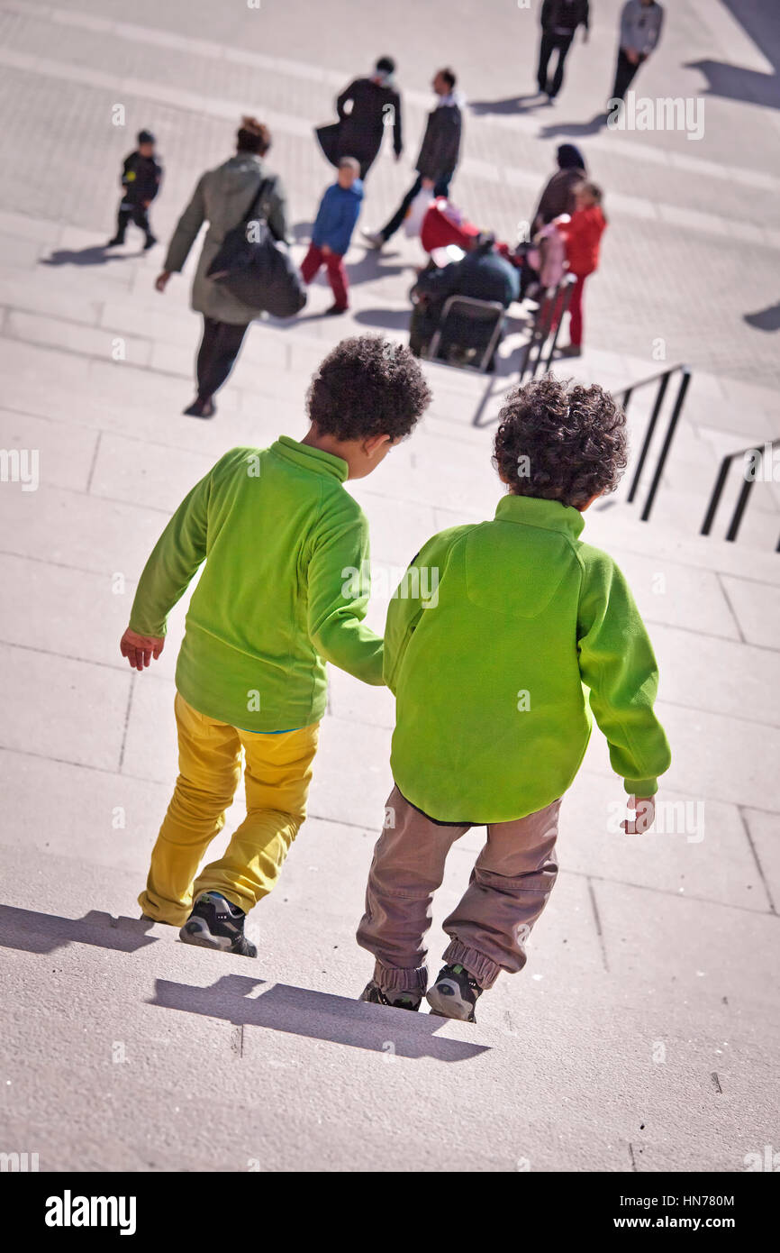 Two children holding hands school hi-res stock photography and images ...
