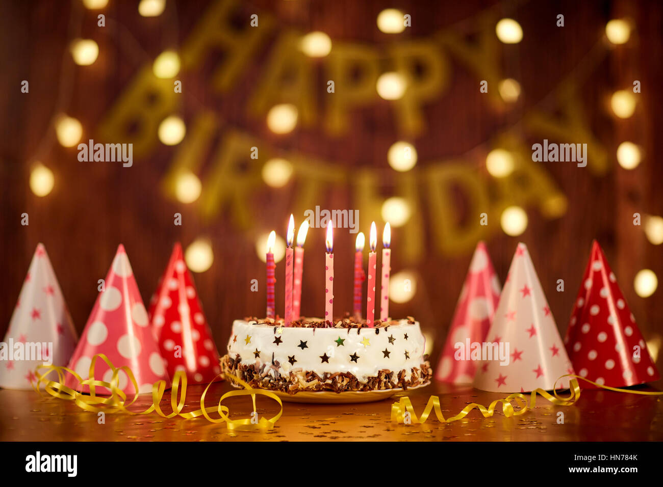 Happy birthday cake with candles on the background of garlands a Stock  Photo - Alamy