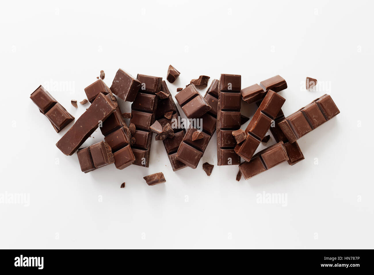 Chunks of Dark Chocolate On White Background. Stock Photo