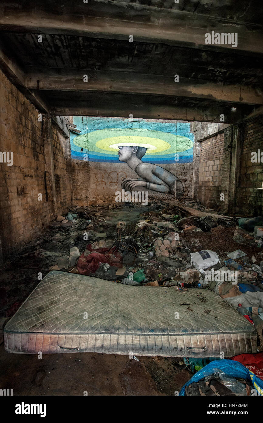 A mattress in the garbage symbolizes the decay of the central aisle