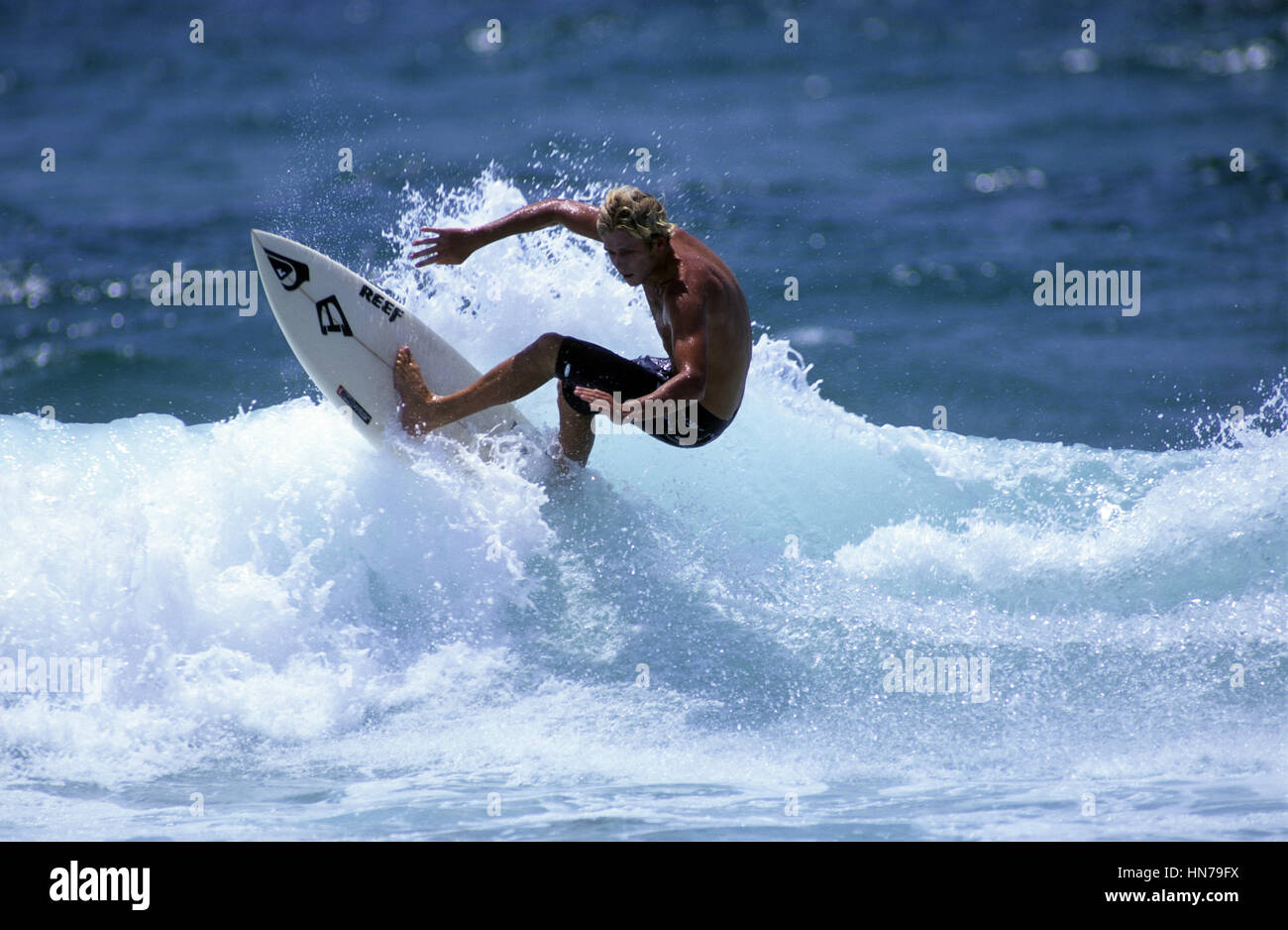 Surferturns off the top of the wave Stock Photo