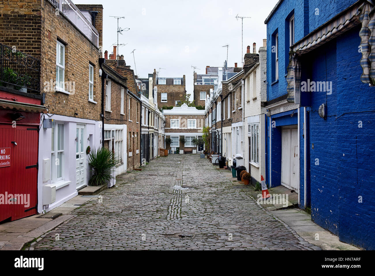 LONDON CITY - DECEMBER 25, 2016: Denbigh Close a small cobblestone covered alley with low apartment buildings seen from Portobello Road Stock Photo