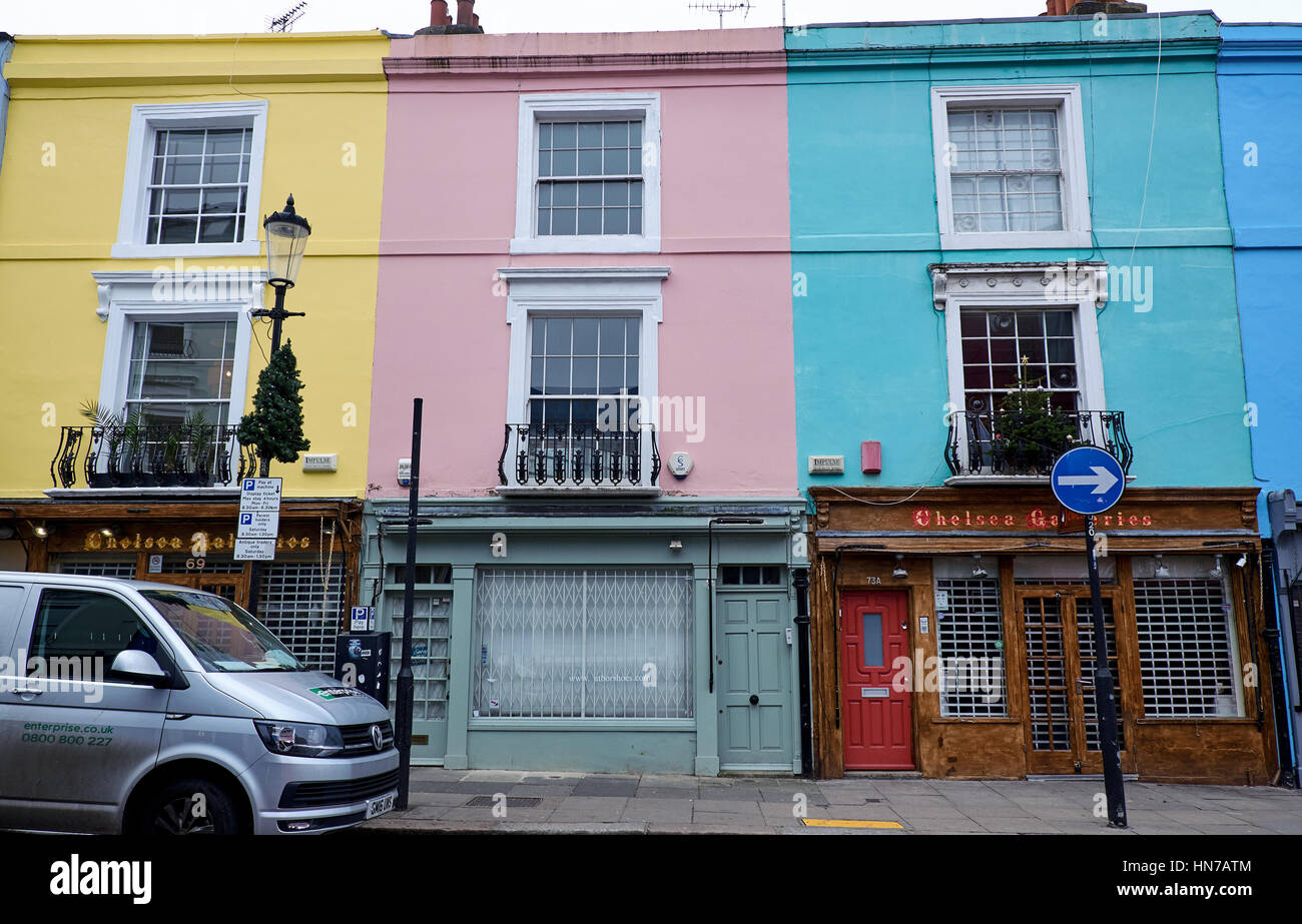 LONDON CITY - DECEMBER 25, 2016: The famous pastel colored apartment facades in  Portobello Road in Nottinghill with store fronts Stock Photo