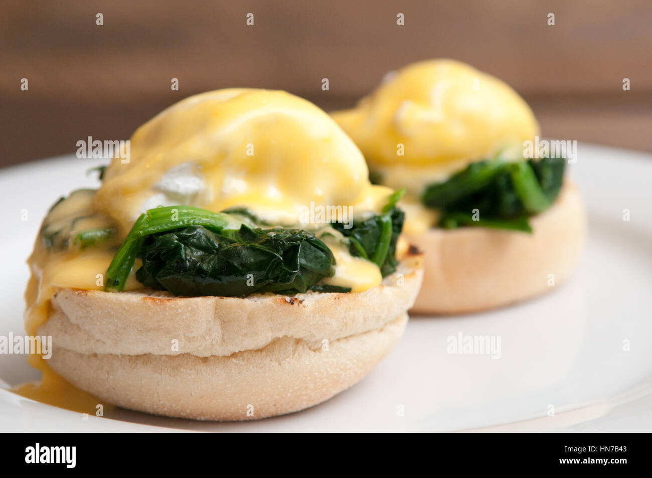 Eggs benedict or eggs florentine on a white plate in the cafe Stock Photo Alamy