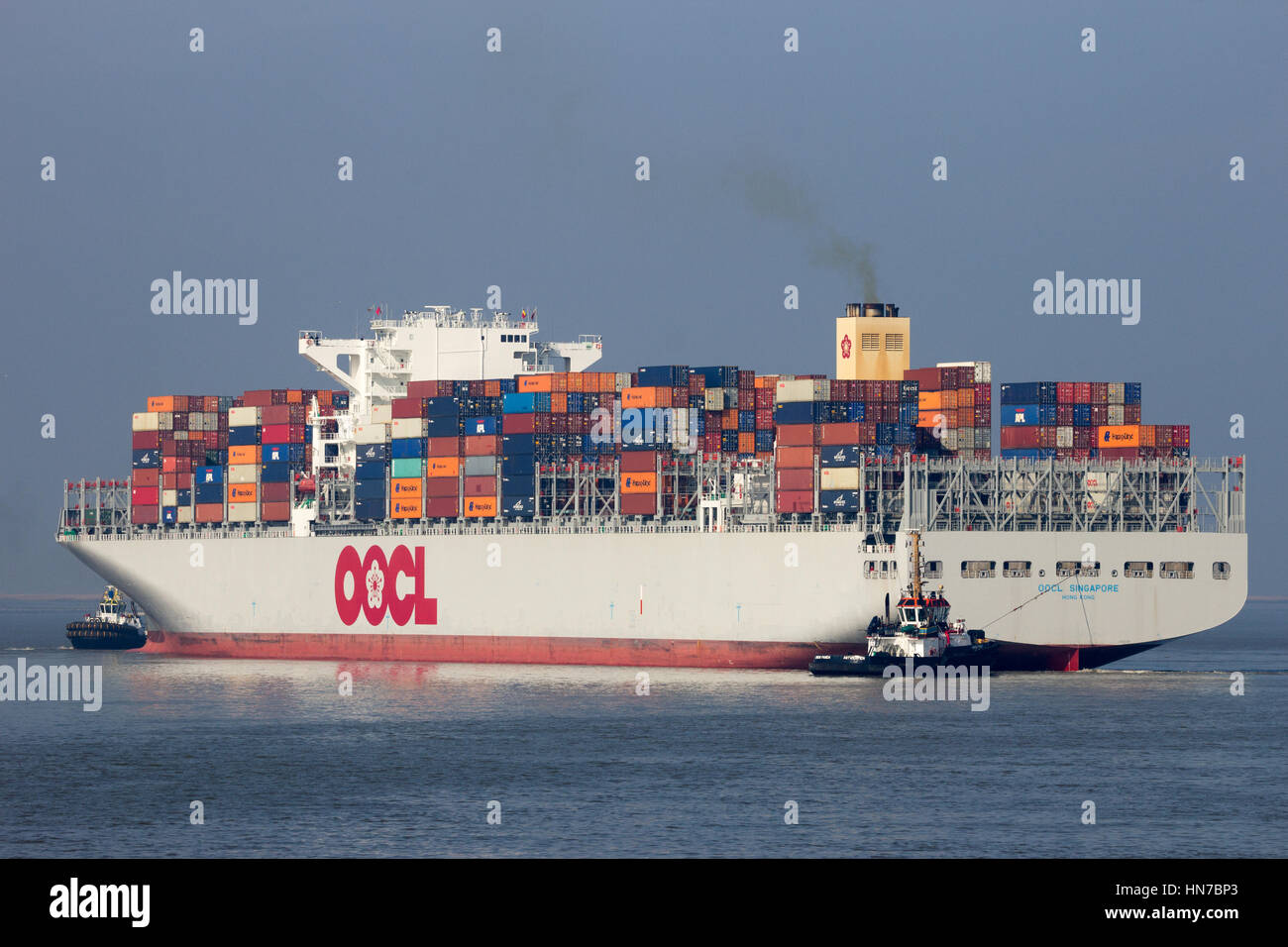 ANTWERP, BELGIUM - MAR 12, 2016: Container ship OOCL Singapore leaving a container terminal in the Port of Antwerp. Stock Photo