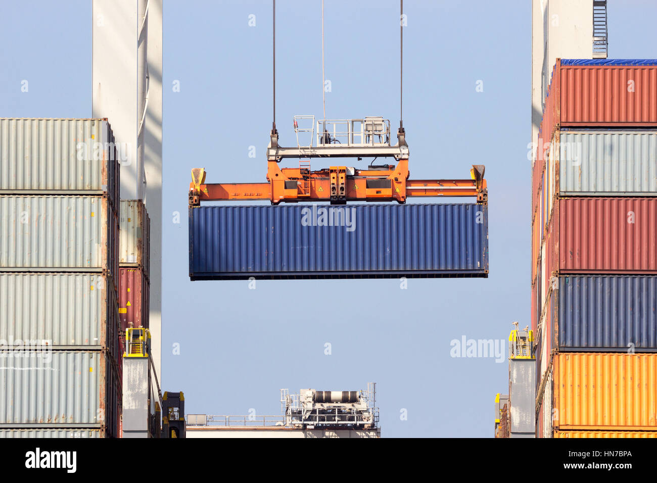 Sea container loaded onto a ship with a gantry crane in the Port of Rotterdam. Stock Photo
