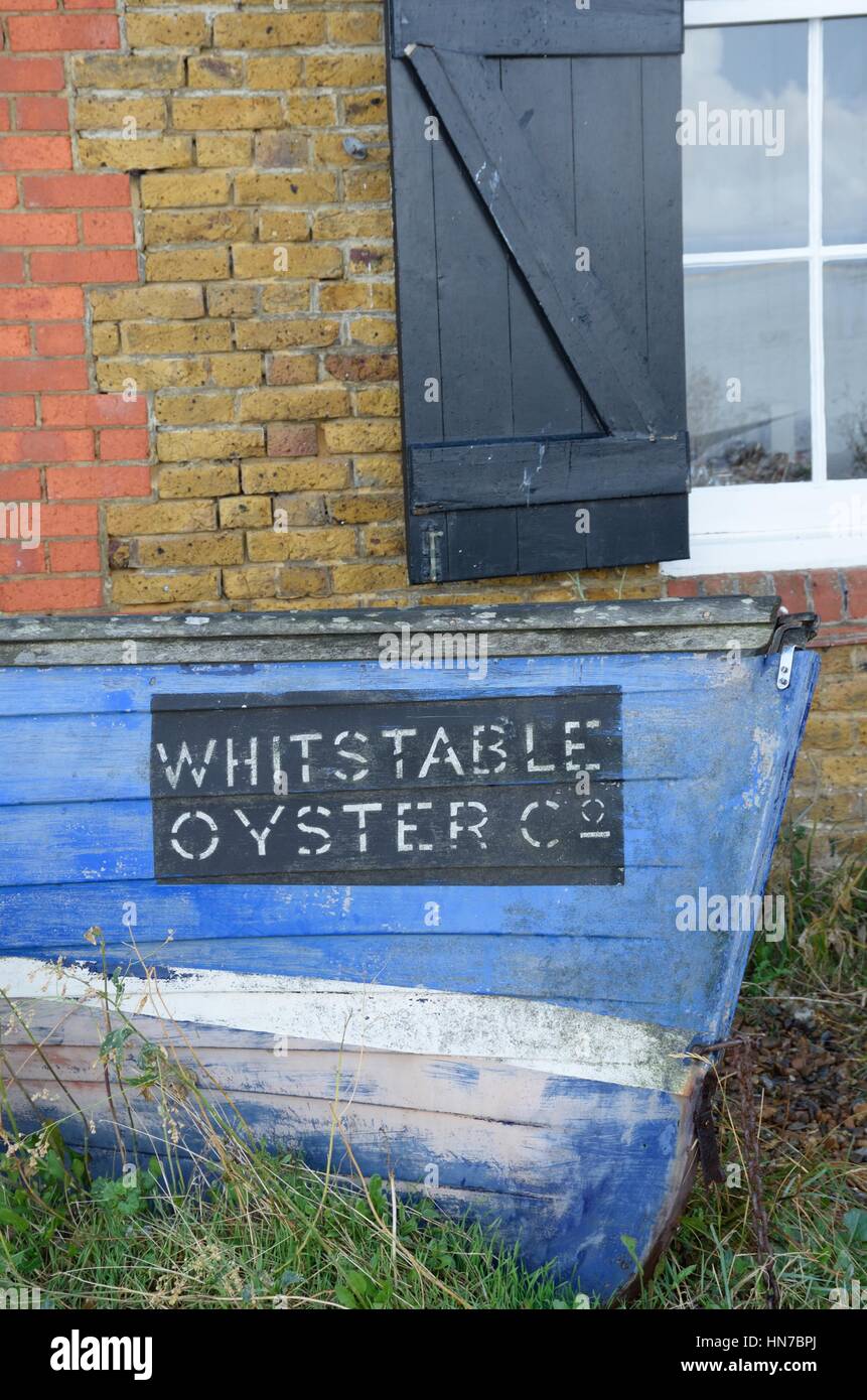 Whitstable, United Kingdom -October 1, 2016: Old Oyster Boat outside brick building Stock Photo