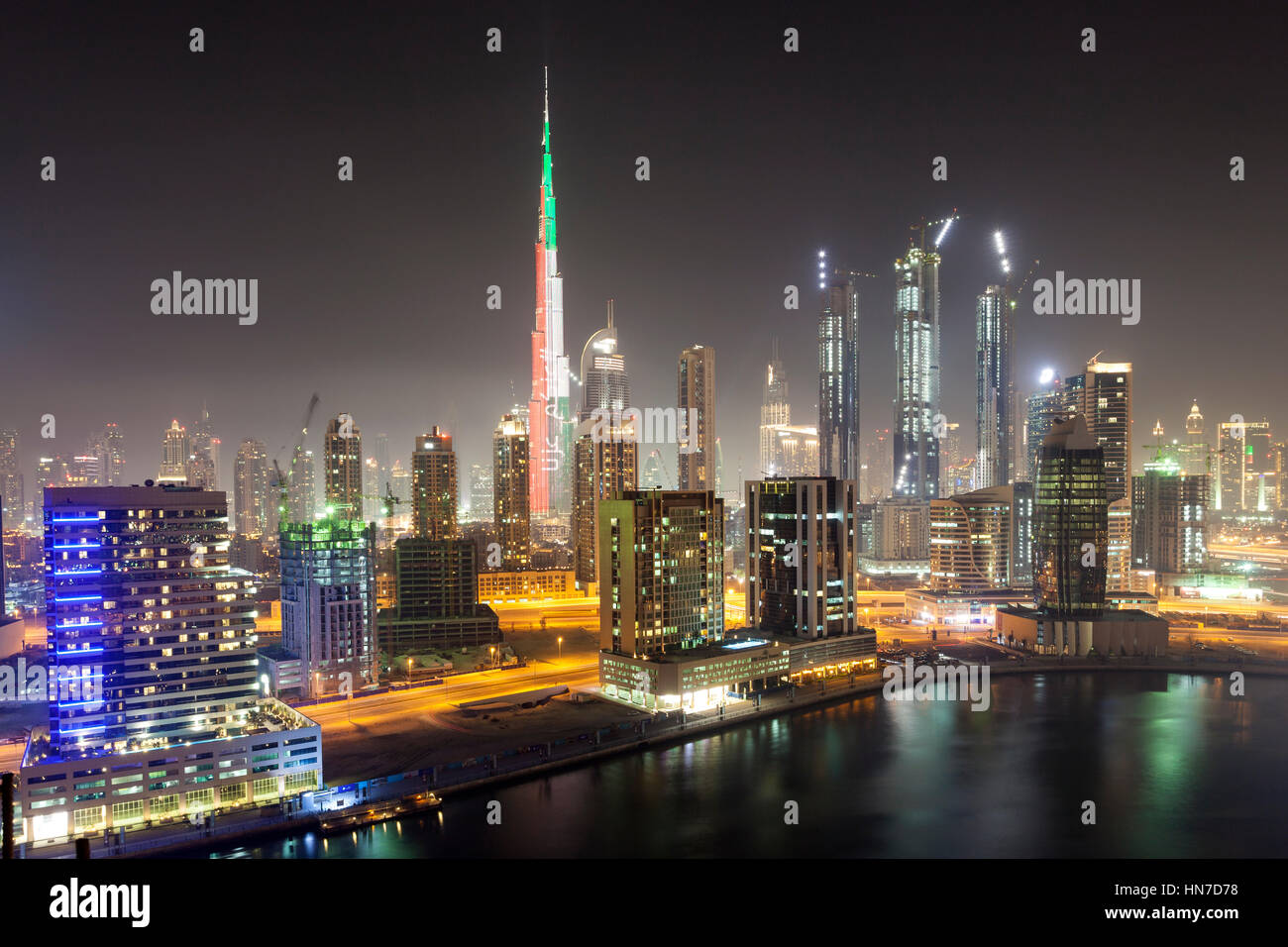 DUBAI, UAE - DEC 5, 2016: Skyline of Dubai downtown at night. Burj Khalifa illuminated in national colors. United Arab Emirates, Middle East Stock Photo