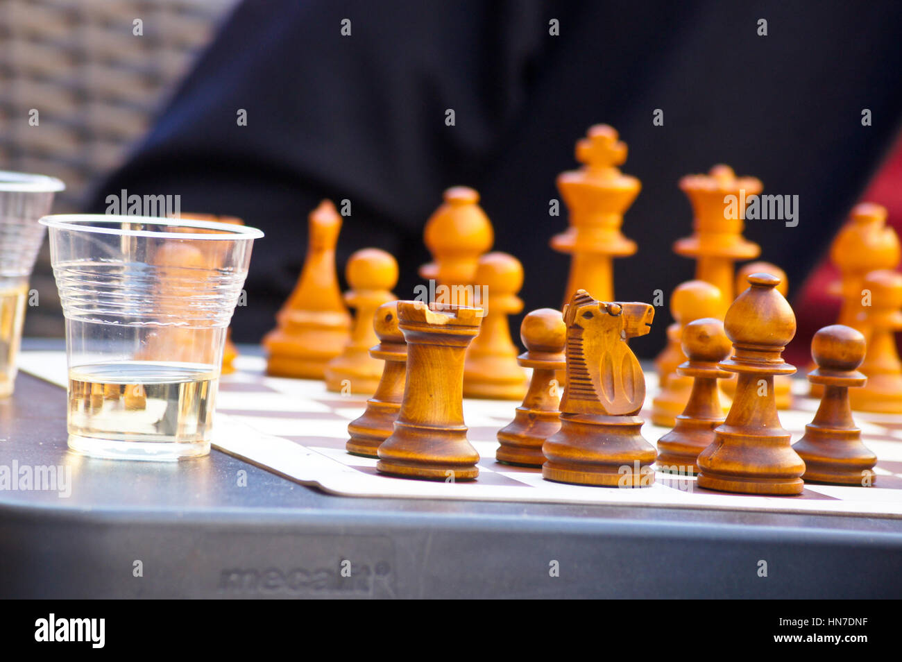 Wooden chess pieces at an outdoor restaurant table, Toulouse, Haute-Garonne, Occitanie, France Stock Photo