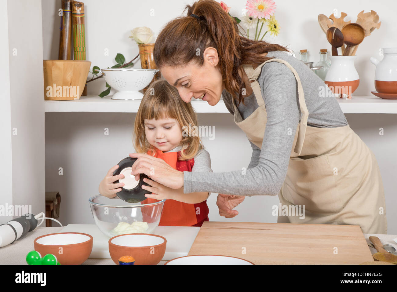 Waitress serving birthday cake to mother and daughter - Stock Image -  F033/5627 - Science Photo Library