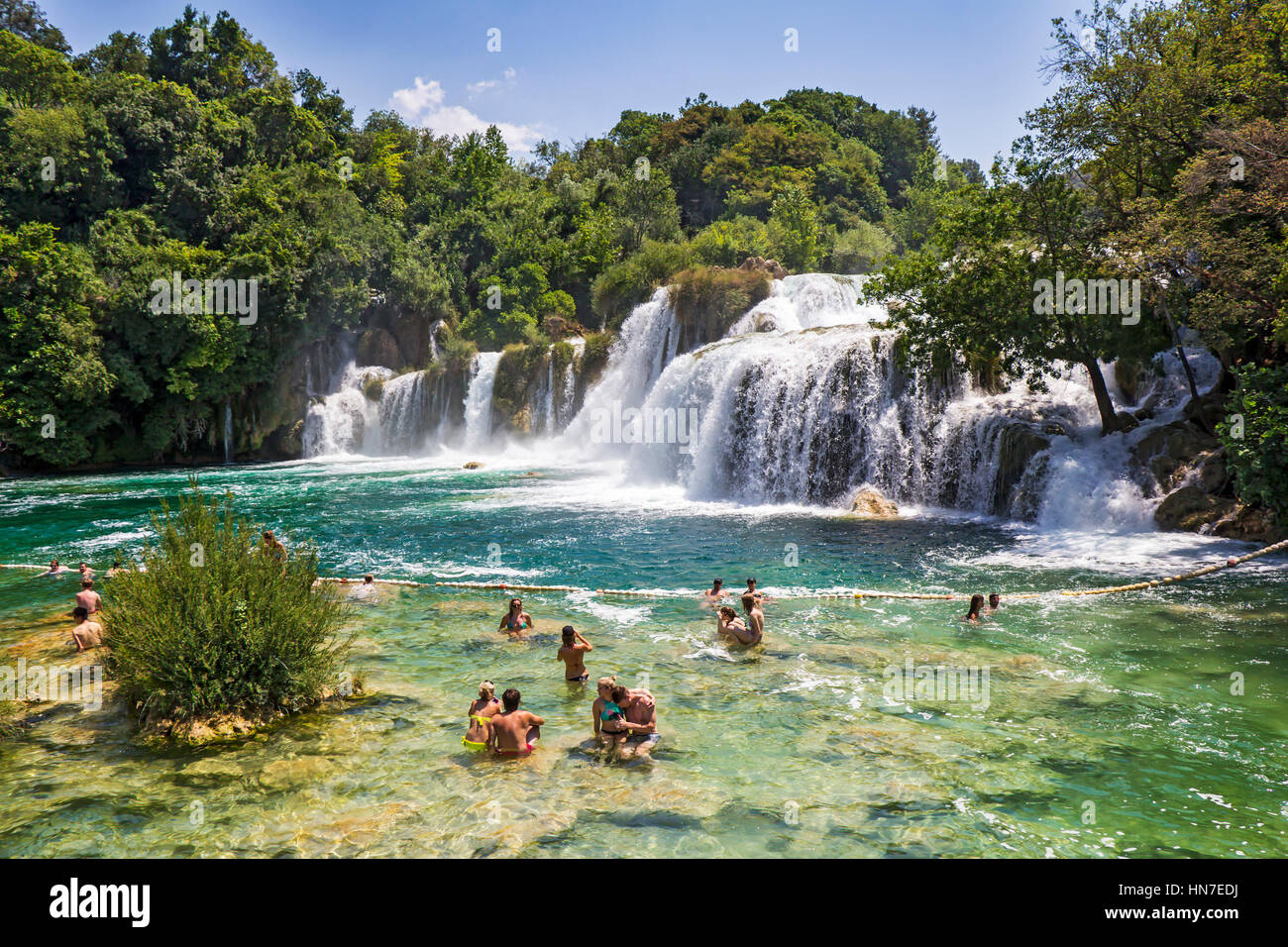 KRKA NATIONAL PARK, CROATIA - JULY 10, 2016: Many tourists  swim  in the Krka River in the Krka National Park in Croatia. This is one of the most famo Stock Photo