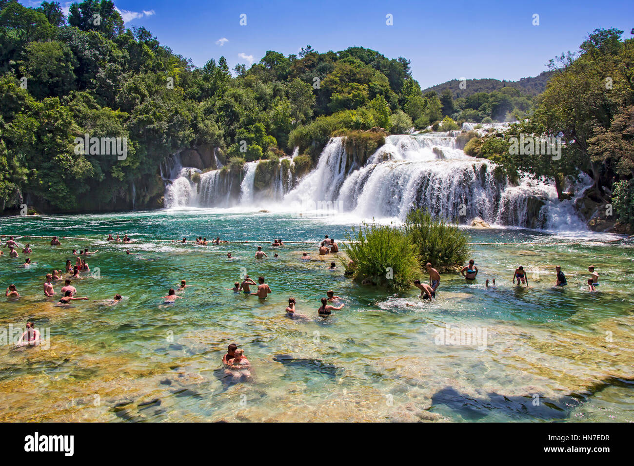 KRKA NATIONAL PARK, CROATIA - JULY 10, 2016: Many tourists  swim  in the Krka River in the Krka National Park in Croatia. This is one of the most famo Stock Photo