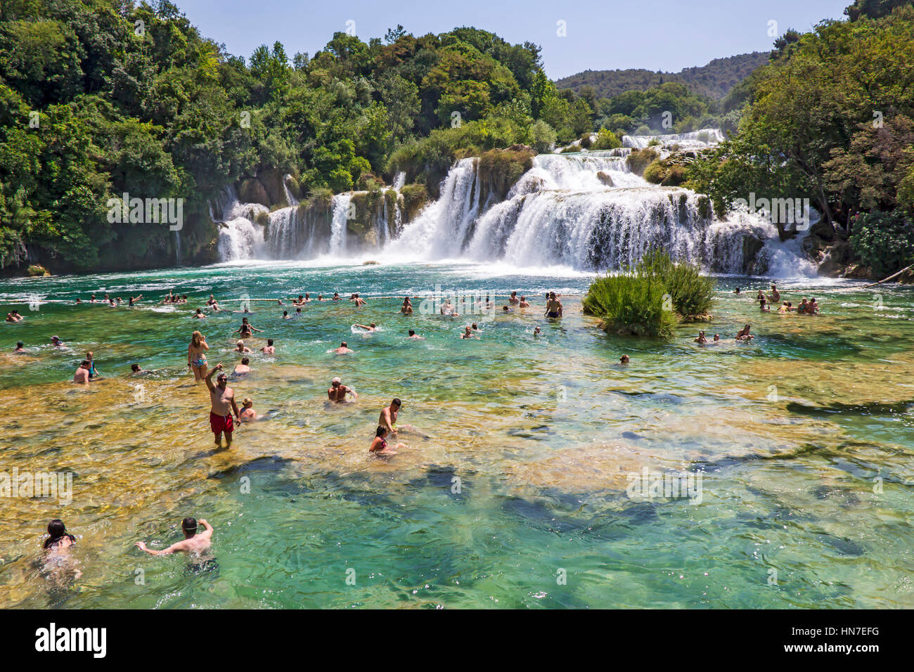 KRKA NATIONAL PARK, CROATIA - JULY 10, 2016: Many tourists  swim  in the Krka River in the Krka National Park in Croatia. This is one of the most famo Stock Photo