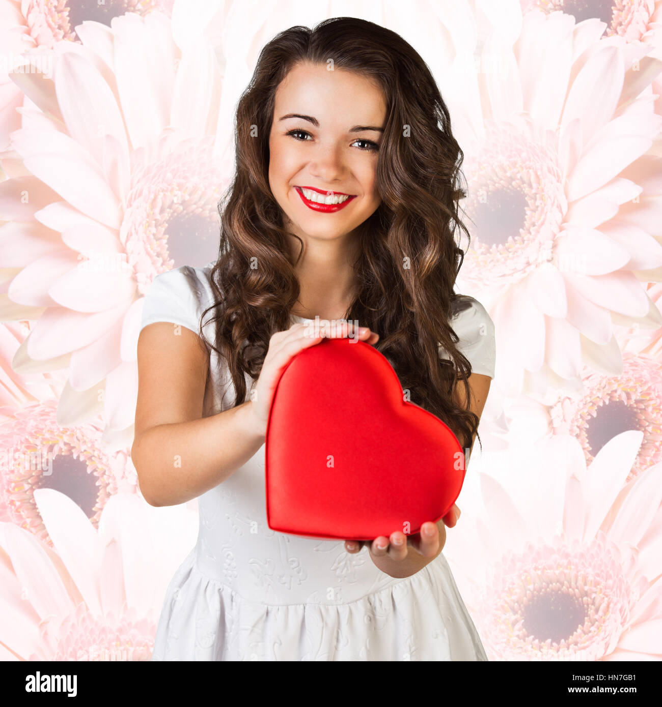 Happy woman hold Love symbol red heart. Stock Photo