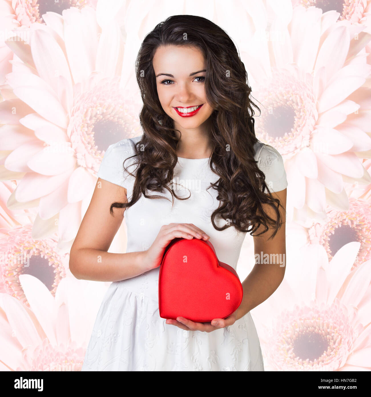 Happy woman hold Love symbol red heart. Stock Photo