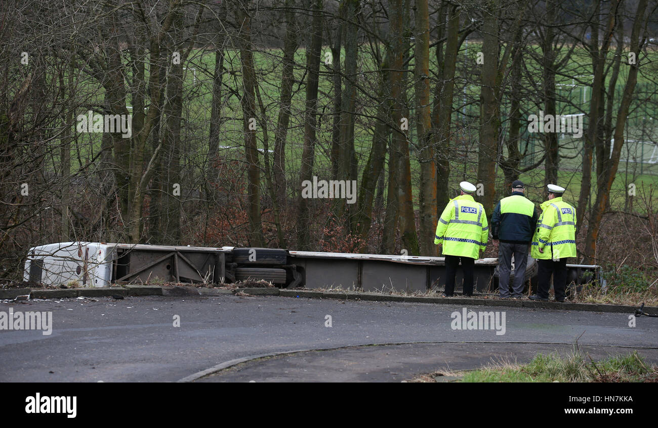 Emergency services look at a school bus which overturned near Our Lady's High in Cumbernauld, Lanarkshire. Stock Photo