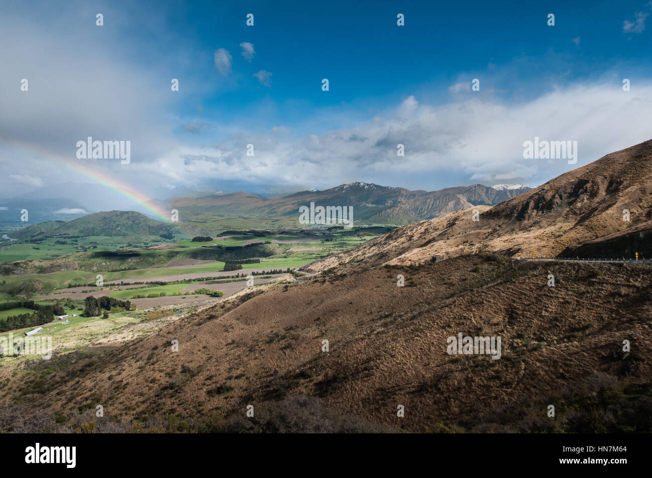 Rainbow in blue sky Stock Photo - Alamy