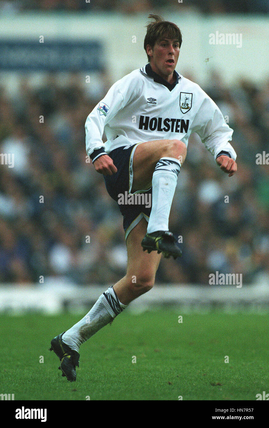 Darren Anderton of Tottenham is shown a yellow card by