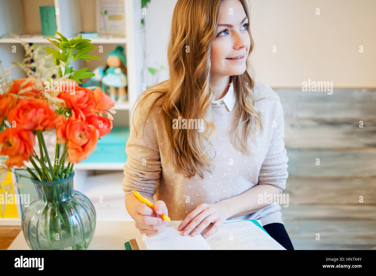 Young businesswoman sitting at desk and working Stock Photo - Alamy