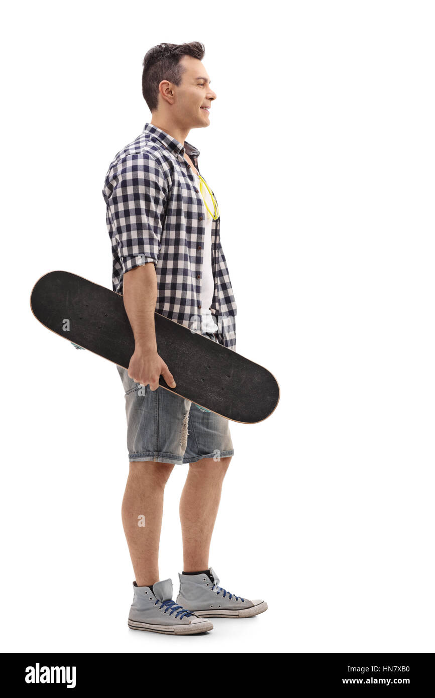 Full length profile shot of a skater holding a skateboard and ...