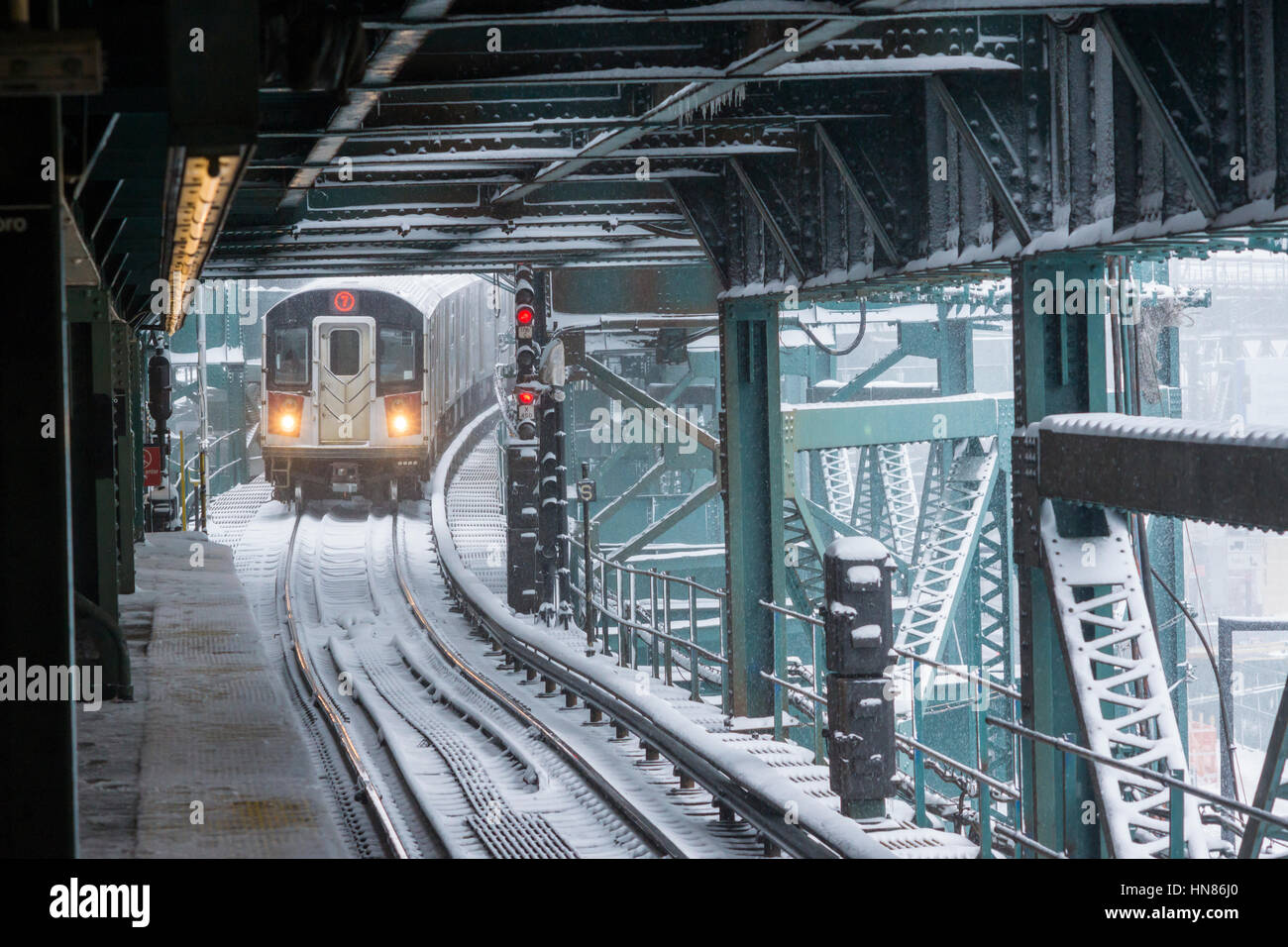 New York, USA. 09th Feb, 2017. A Flushing Line train arrives at the Queensboro Plaza station in New York during the city's first major winter storm of the season on Thursday, February 9, 2017. Meteorologists are forecasting between 8 and 14 inches of snow in the New York City region. The Metropolitan Transportation Authority has had no major delays and the trains continue to run.  Credit: Richard Levine/Alamy Live News Stock Photo