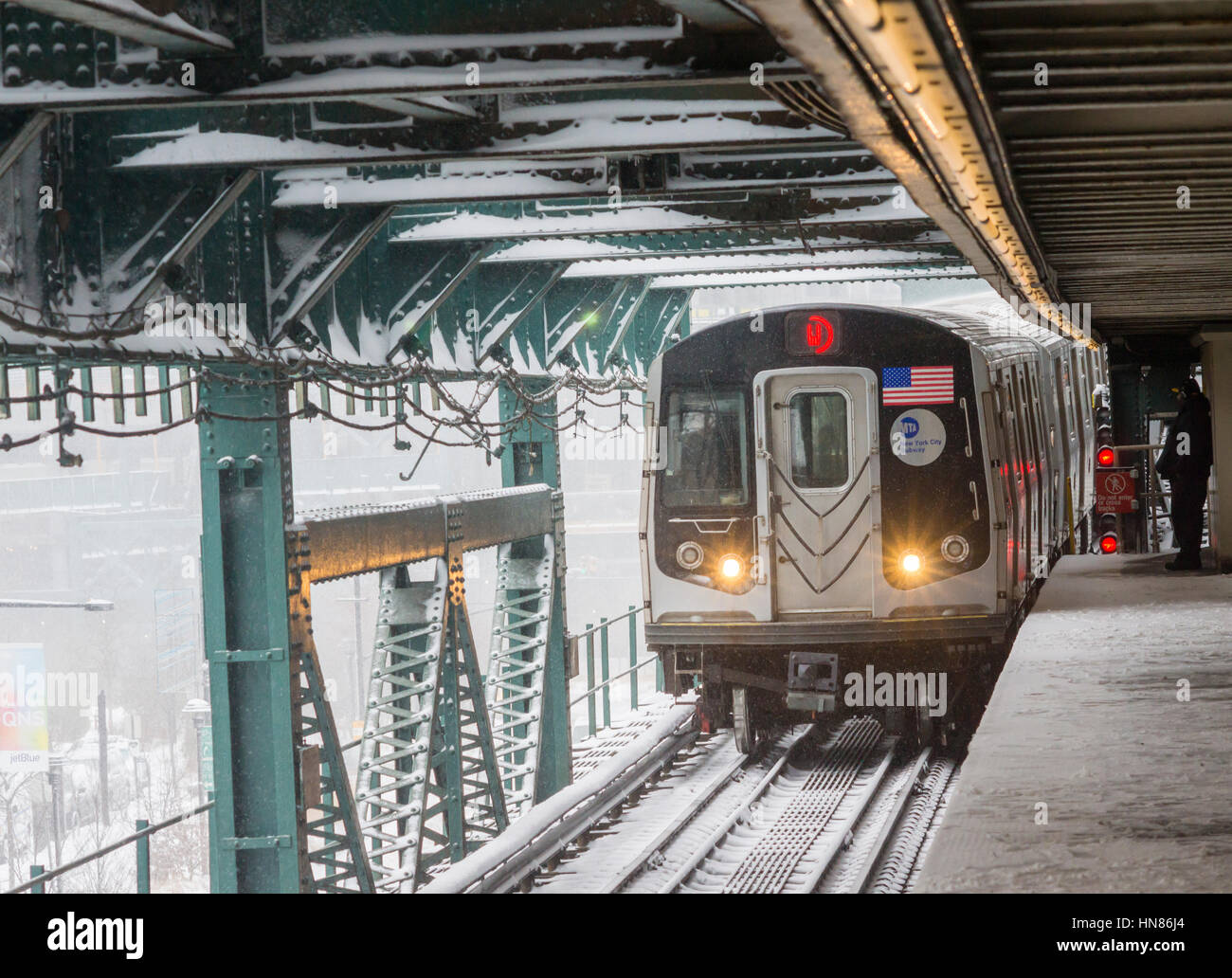 New York, USA. 09th Feb, 2017. An Astoria Line train arrives at the Queensboro Plaza station in New York during the city's first major winter storm of the season on Thursday, February 9, 2017. Meteorologists are forecasting between 8 and 14 inches of snow in the New York City region. The Metropolitan Transportation Authority has had no major delays and the trains continue to run.  Credit: Richard Levine/Alamy Live News Stock Photo