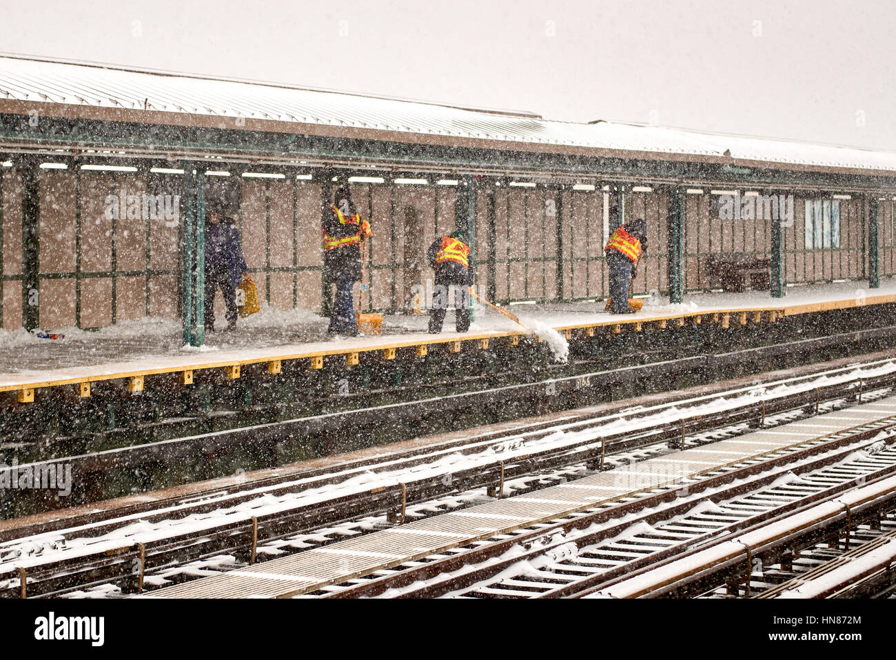 Brooklyn, New York City, USA. 9th Feb, 2017. MTA workers shoveling snow off the D train 71st Street platform on February 9th, 2017. Credit: Jimmy Qiu/Alamy Live News Stock Photo