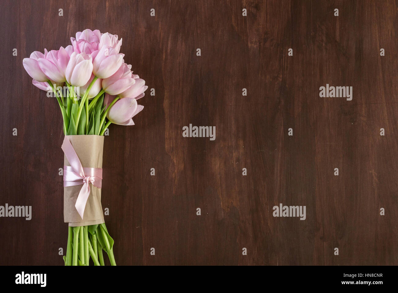 Bouquet of pink tulips on a wood background Stock Photo - Alamy