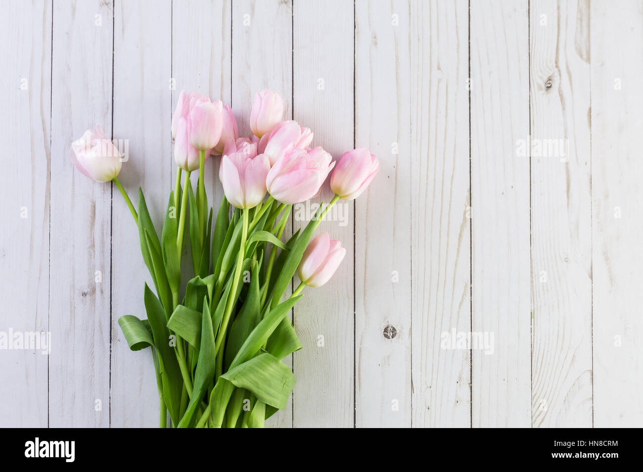 Bouquet of pink tulips on a wood background Stock Photo - Alamy
