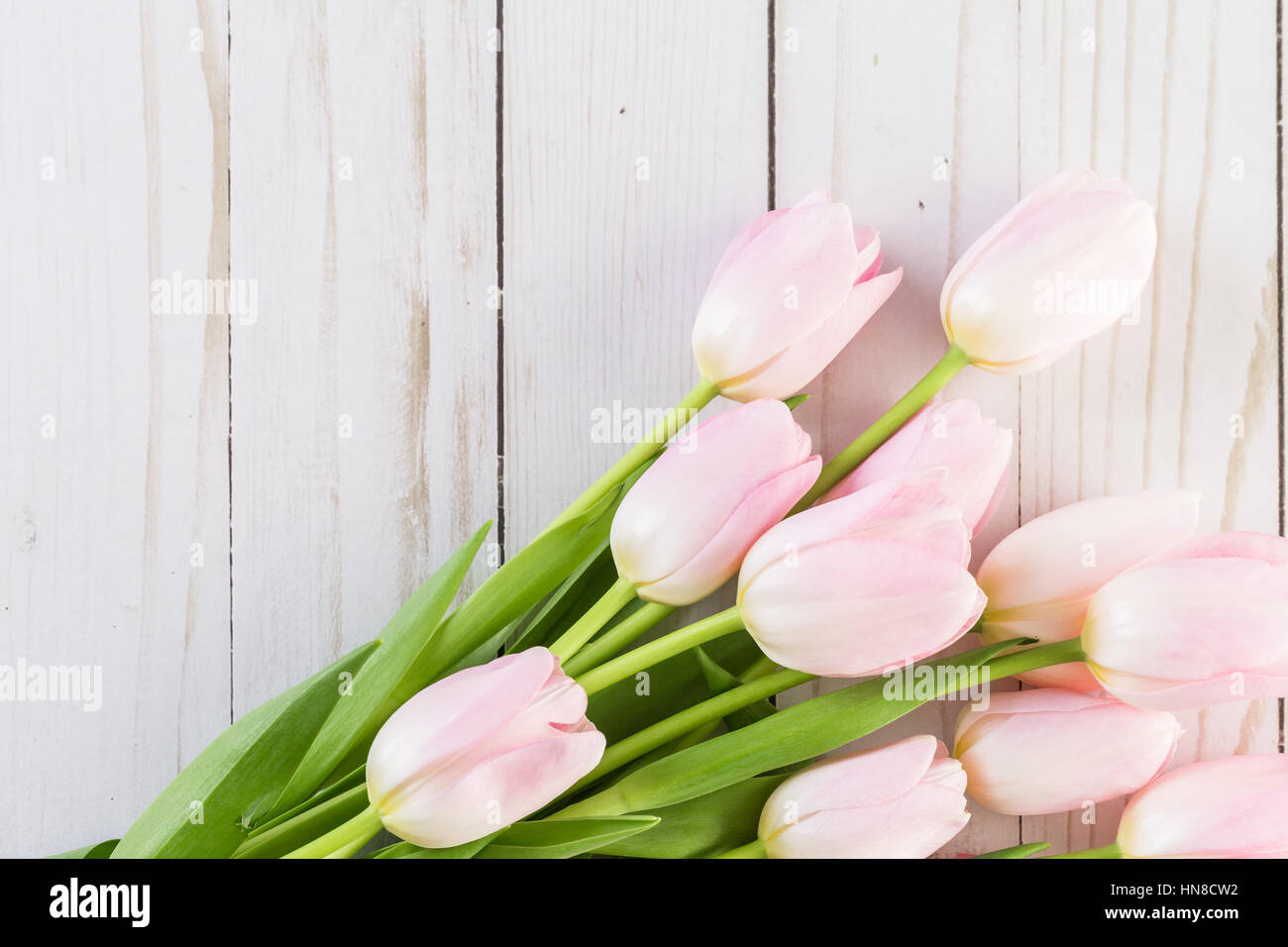 Bouquet of pink tulips on a wood background Stock Photo - Alamy