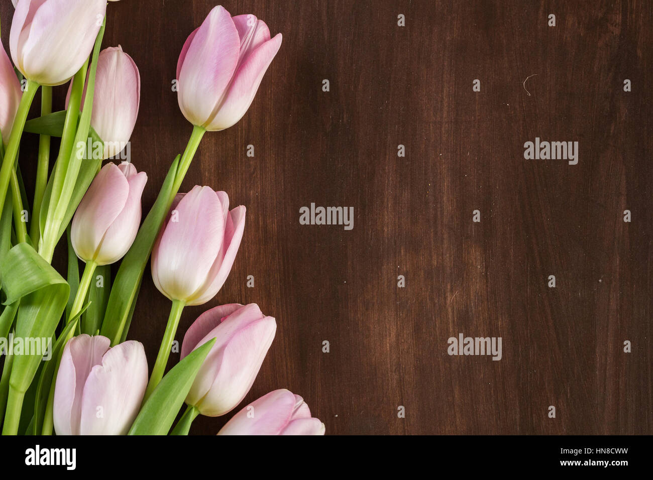 Bouquet of pink tulips on a wood background Stock Photo - Alamy
