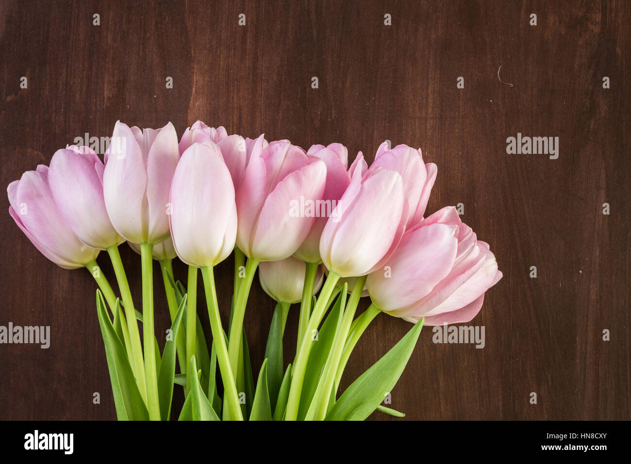 Bouquet of pink tulips on a wood background Stock Photo - Alamy