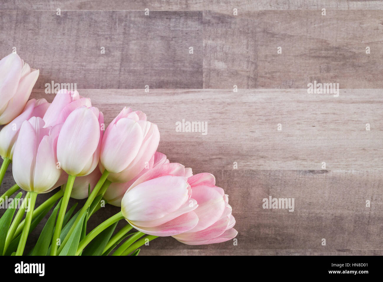 Bouquet of pink tulips on a wood background Stock Photo - Alamy