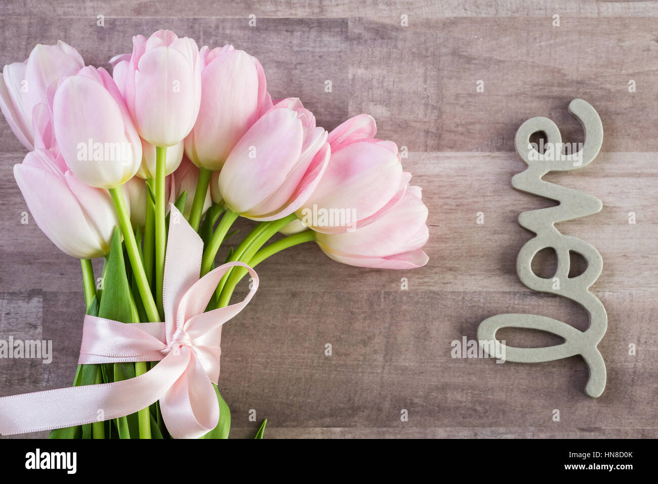 Bouquet of pink tulips on a wood background Stock Photo - Alamy