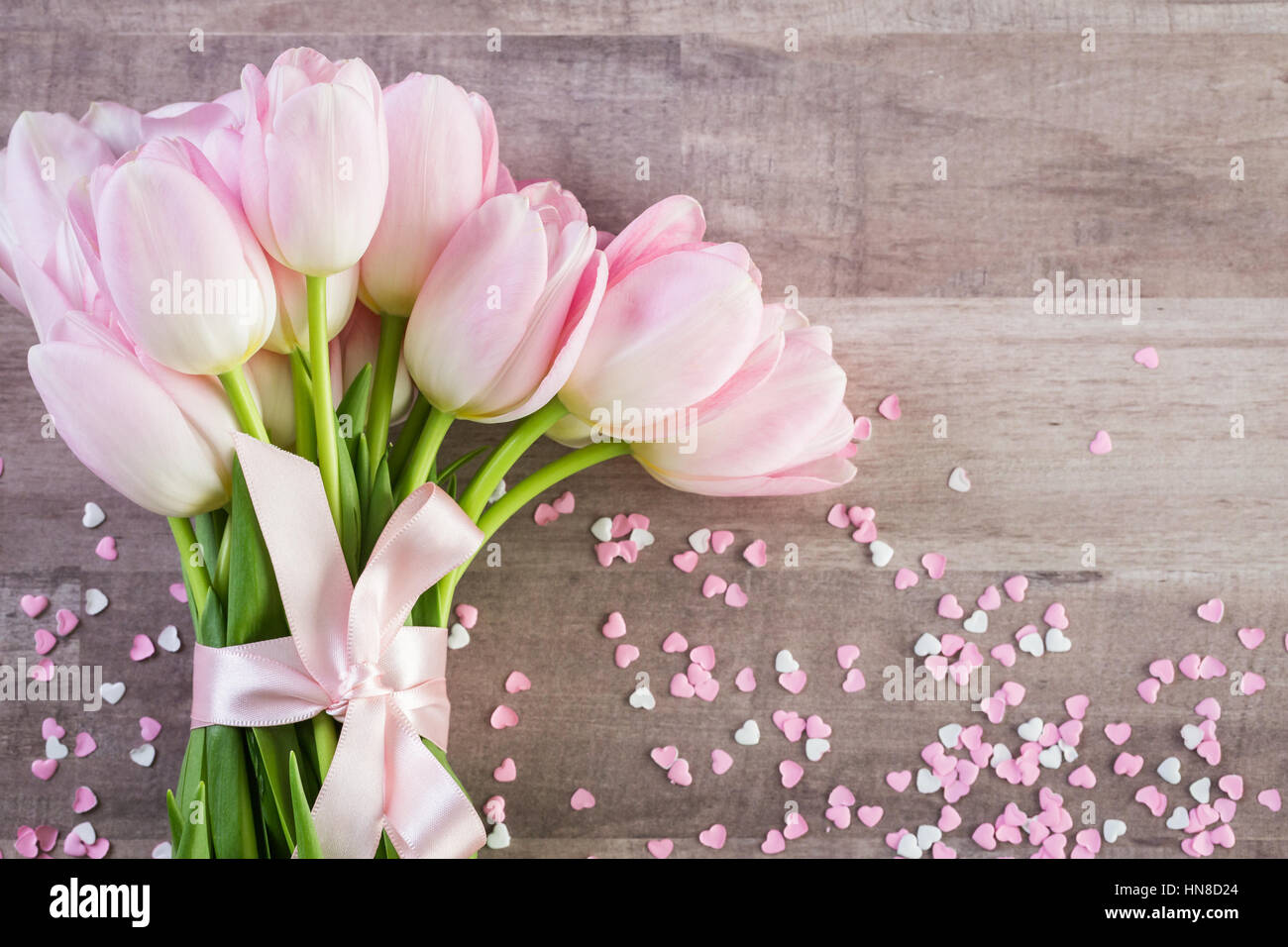 Bouquet of pink tulips on a wood background Stock Photo - Alamy
