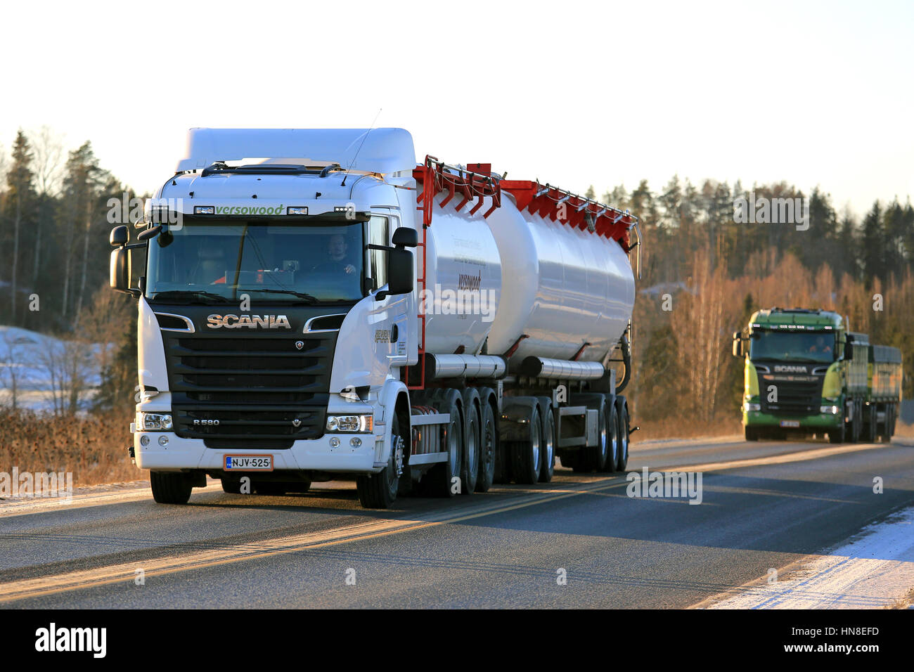 SALO, FINLAND - JANUARY 5, 2017: White Scania R580 bulk transport truck for Versowood and another new Scania combination vehicle drive along road on a Stock Photo