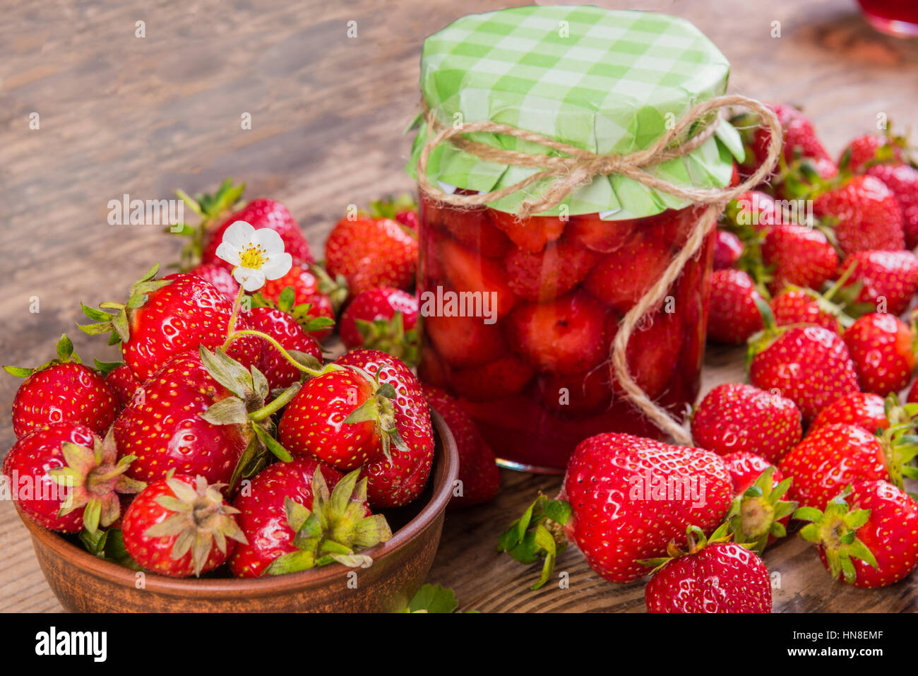 summer fresh red strawberry and jam on wood background Stock Photo - Alamy