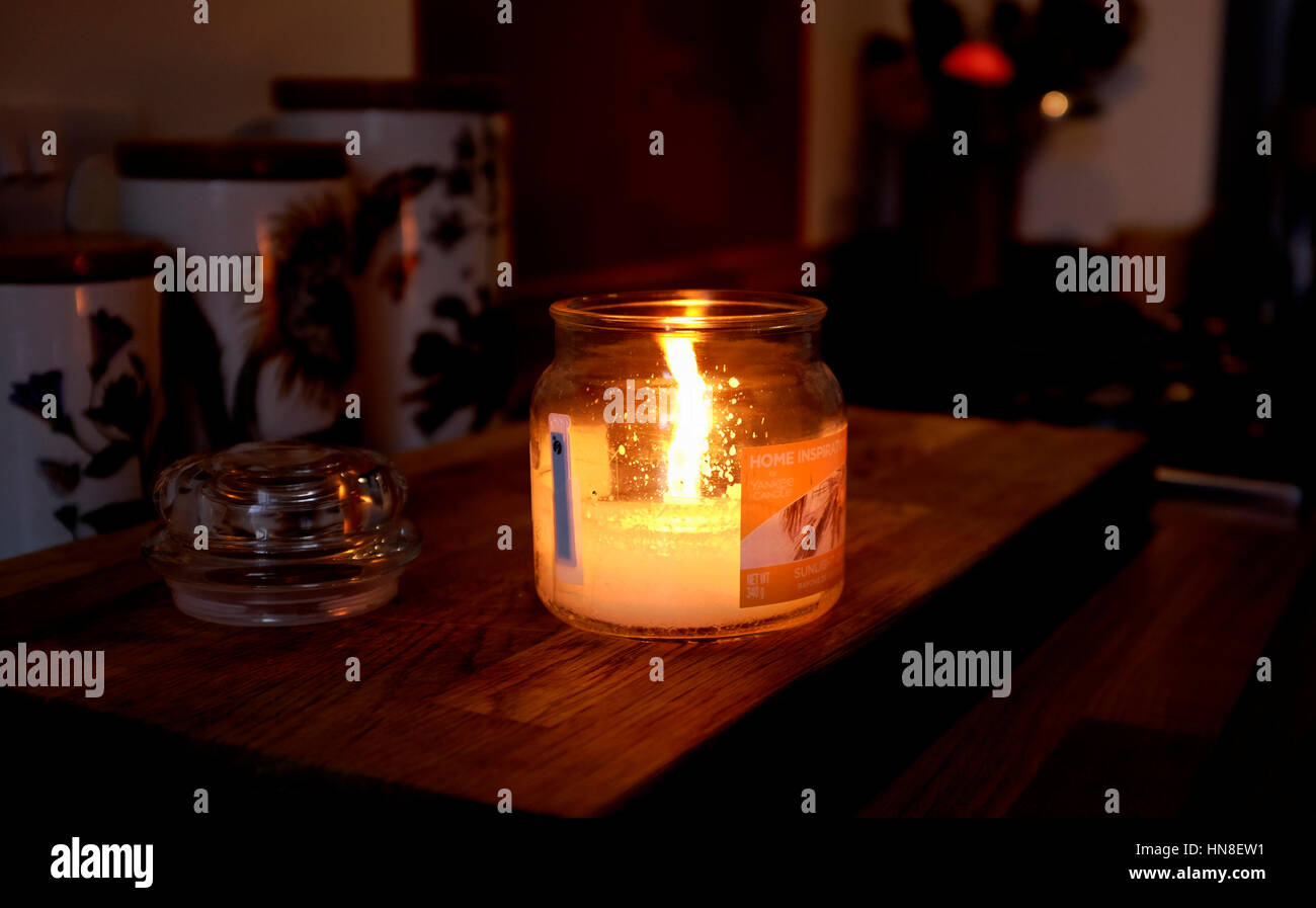 Premium Photo  Cup of tea with hot smoke and three burning candles on the  desk at home power outage