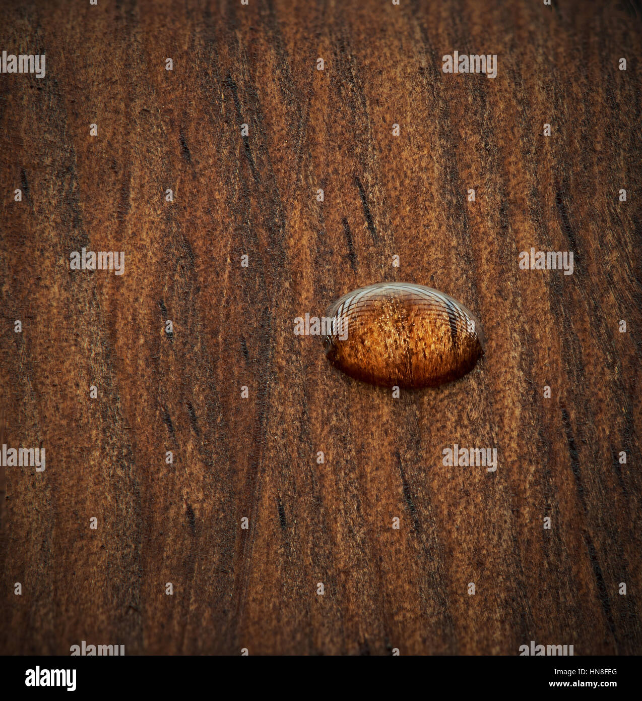 one water drop on dark wood surface Stock Photo