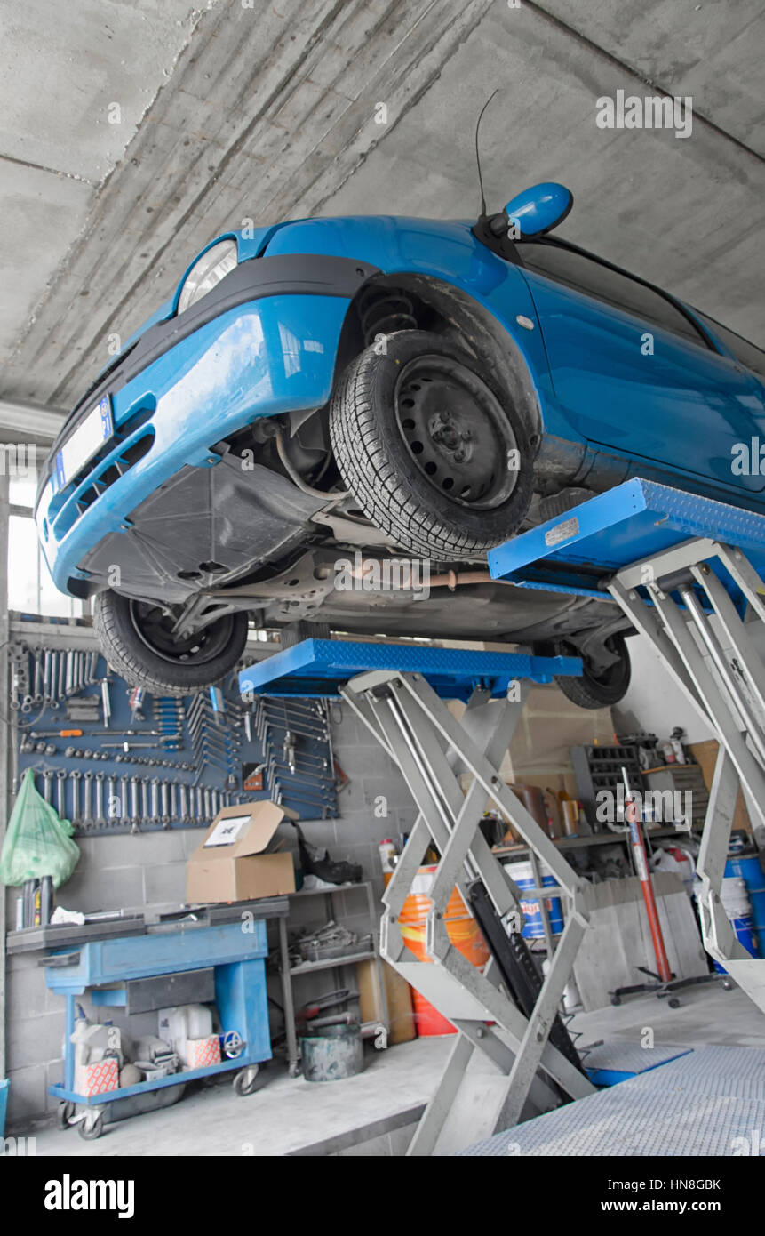 Auto raised by the car lift in a garage Stock Photo