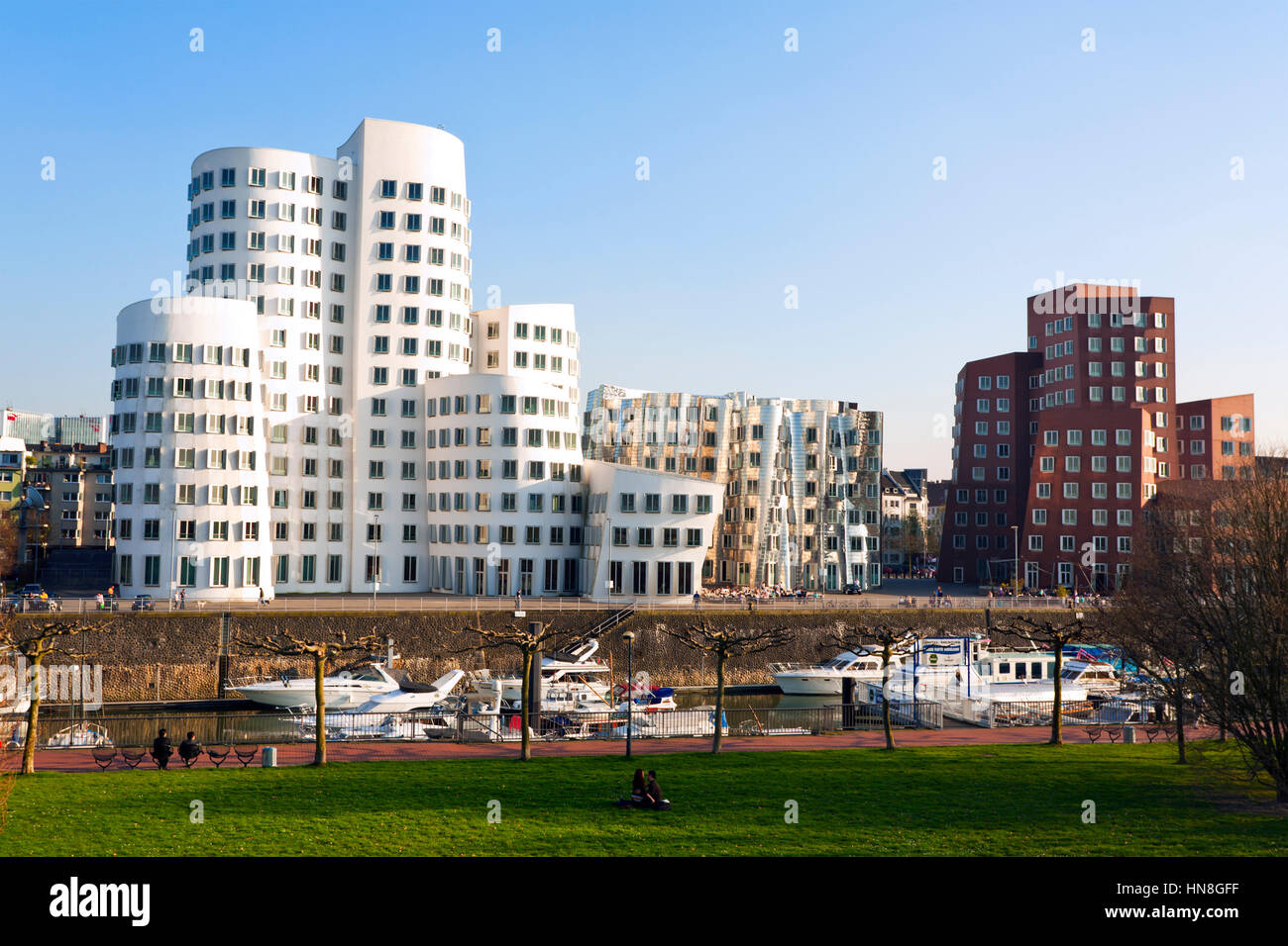 Dusseldorf, Germany - April 3, 2009: Frank Owen Gehry's Neuer Zollhof buildings at the MedienHafen with marina in foreground. Stock Photo