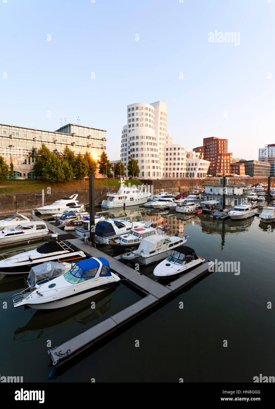 Dusseldorf, Germany - July 4, 2009: Frank Owen Gehry's Neuer Zollhof buildings at the MedienHafen with the marina in foreground Stock Photo